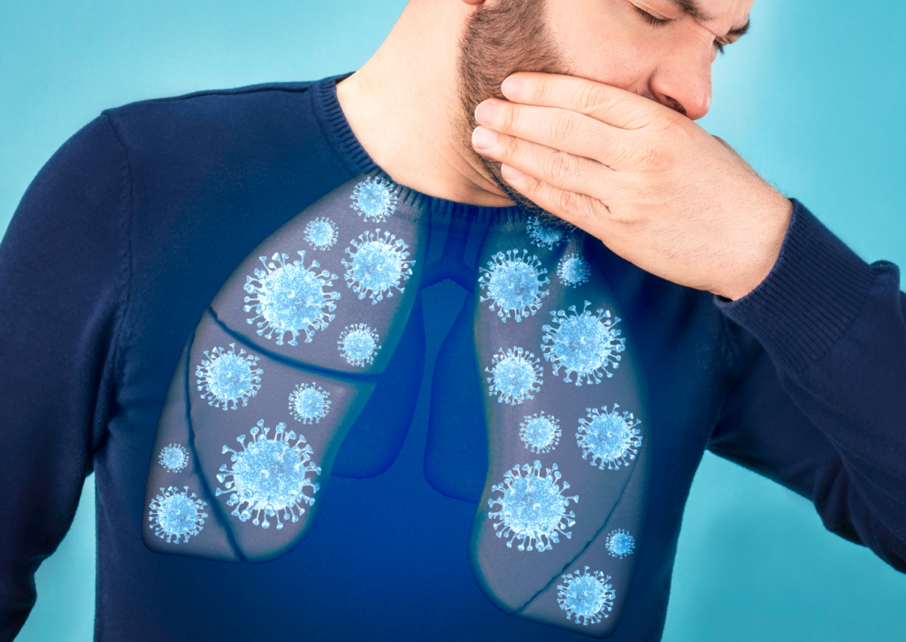 Man covering his mouth while coughing with a visual representation of germs in the lungs, highlighting the need for a healthy, non-toxic environment.