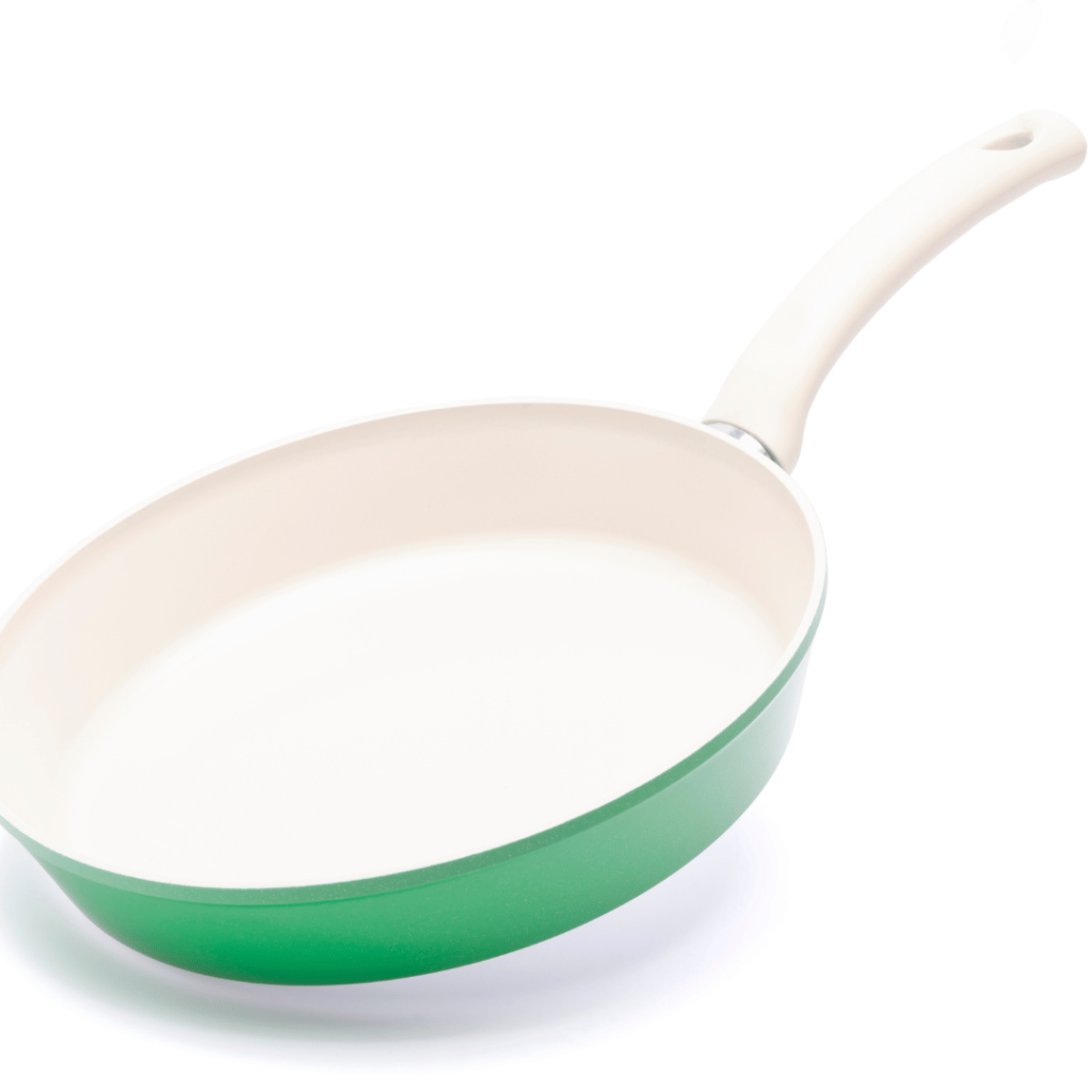 ceramic vs stainless steel cookware. Picture of a green ceramic pan with white cooking surface.  