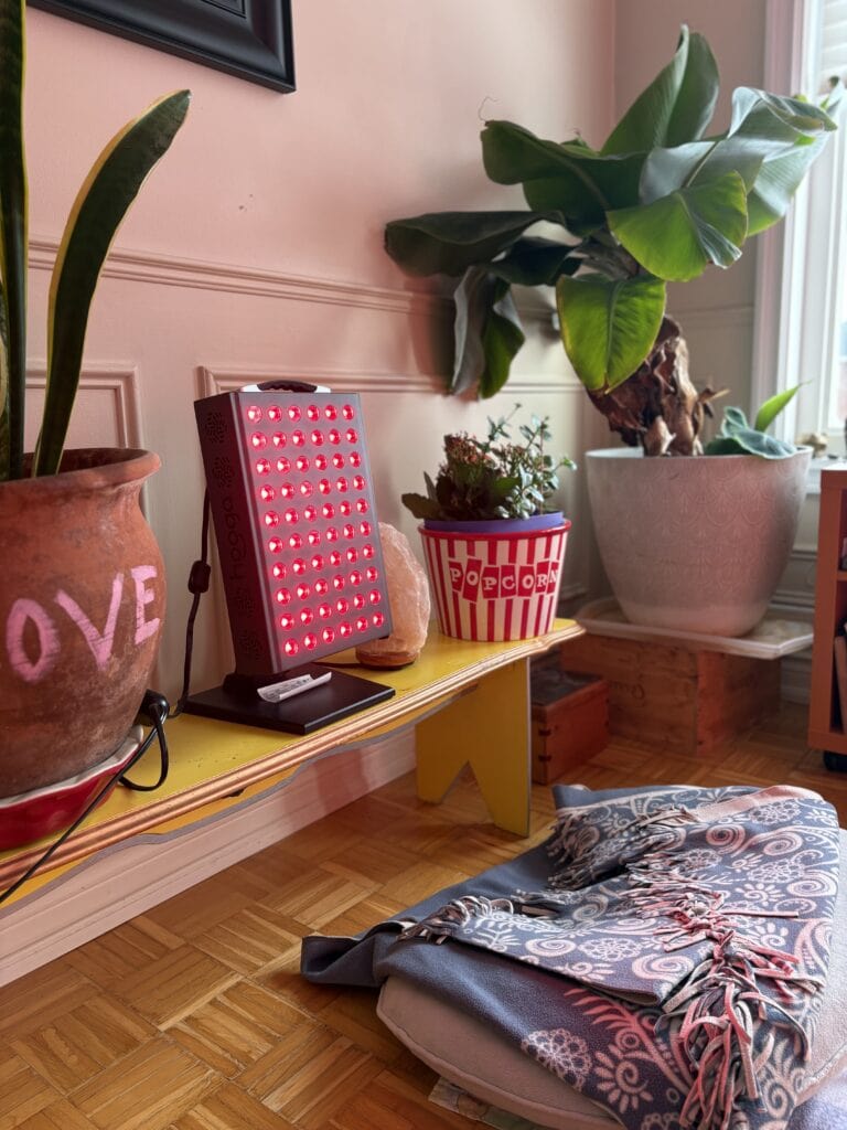 Meditation corner with Hooga Pro 300 red-light therapy panel glowing, used for thyroidectomy and wellness routine.